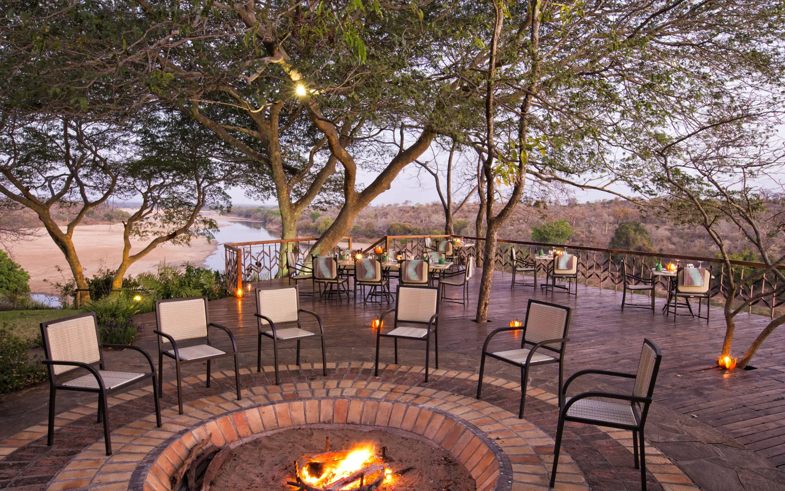 Riverside deck with fire pit and comfortable seating at dusk, Chilo Gorge Safari Lodge, Gonarezhou & Malilangwe, Zimbabwe