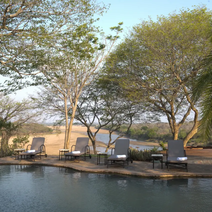 Riverside lounge area with seating overlooking water and trees, Chilo Gorge Safari Lodge, Gonarezhou & Malilangwe, Zimbabwe