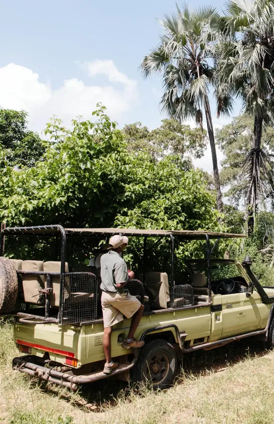 Open-sided safari vehicle with passengers on bush road, Chilo Gorge Safari Lodge, Gonarezhou & Malilangwe, Zimbabwe