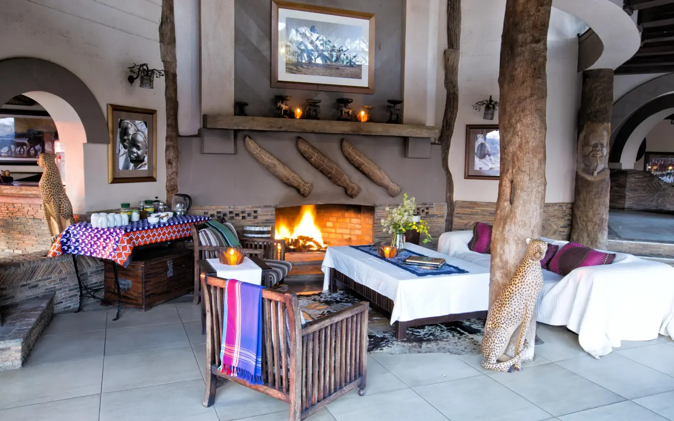 Safari lodge lounge with fireplace, wooden beams, and wildlife decor, Chilo Gorge Safari Lodge, Gonarezhou & Malilangwe, Zimbabwe