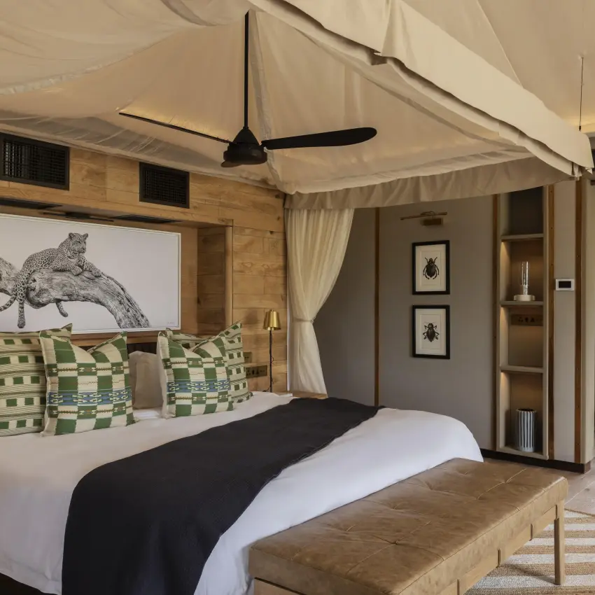 Luxury bedroom with canopy bed and cream drapes, Chitabe Camp, The Okavango Delta, Botswana
