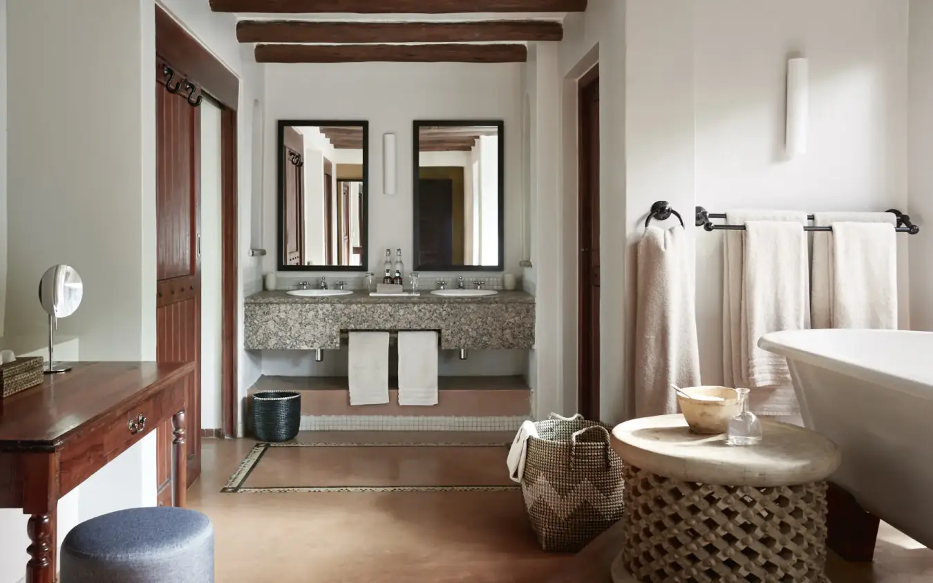 Luxury bathroom with freestanding tub and dual vanity with exposed beam ceiling, Chobe Chilwero, Chobe, Botswana