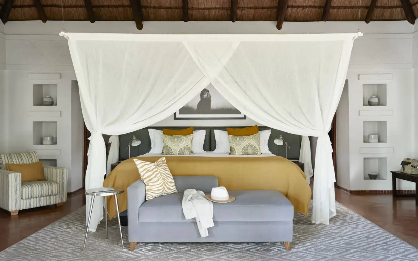 Luxury bedroom suite with four-poster bed and flowing white curtains, Chobe Chilwero, Chobe, Botswana