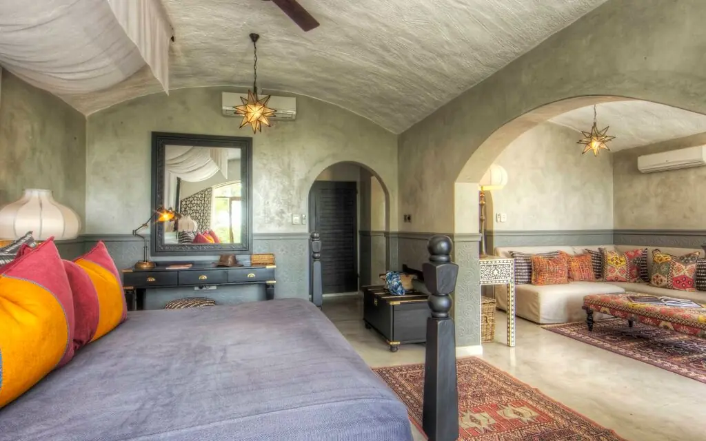Luxury bedroom suite with arched doorways and colorful cushions, Chobe Game Lodge, Chobe, Botswana