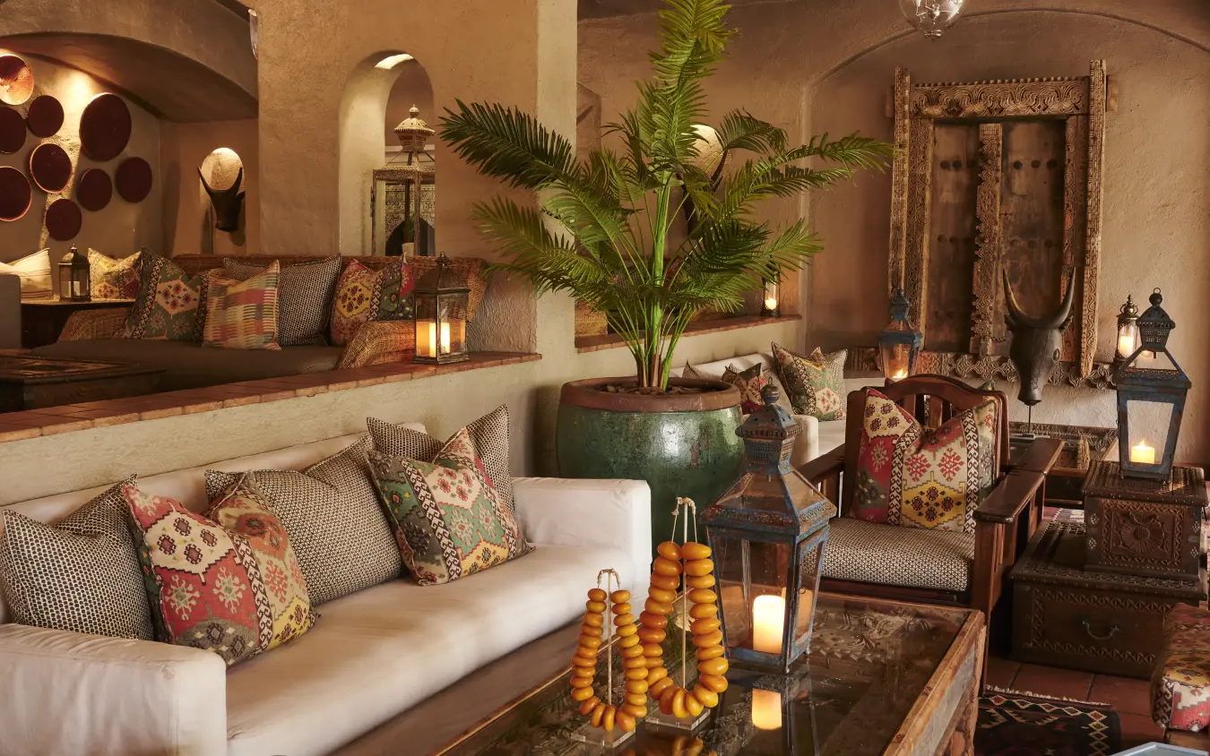 Luxury lounge with earth tones, decorative pillows and potted palms indoors, Chobe Game Lodge, Chobe, Botswana
