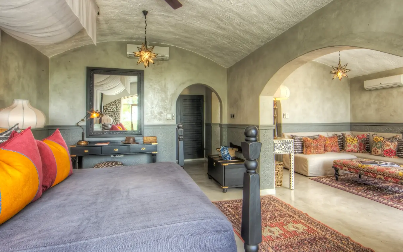 Luxury bedroom suite with arched alcove and colorful cushions, Chobe Game Lodge, Chobe, Botswana