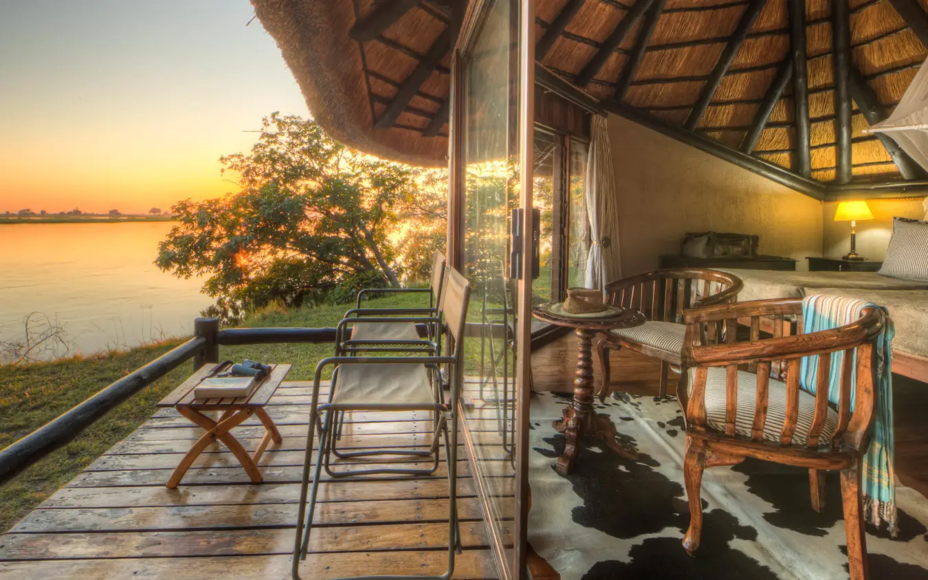 Waterfront deck at sunset with lounge chairs and river view, Chobe Savanna Lodge, Zambezi Region, Namibia