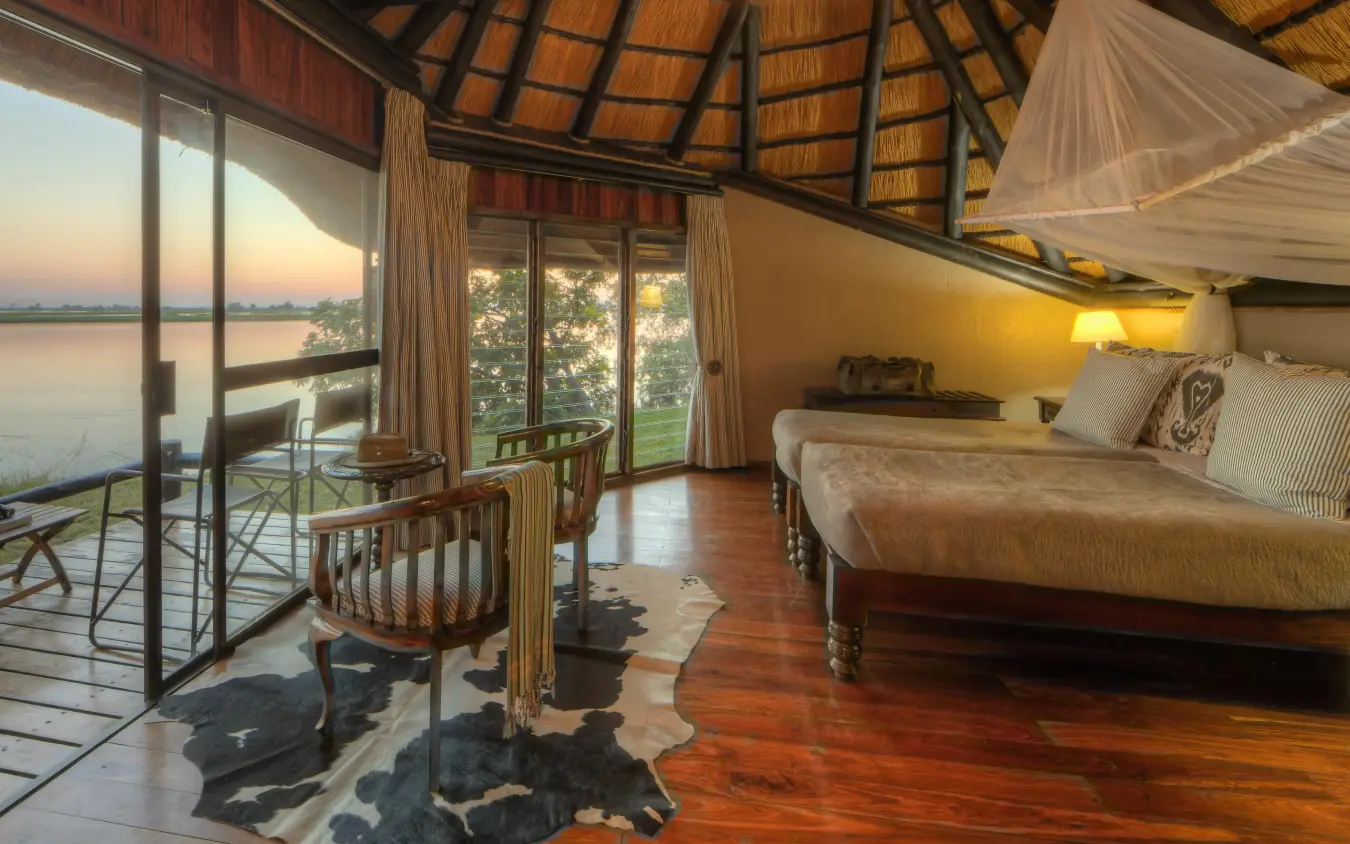Bedroom suite with river views at sunset, Chobe Savanna Lodge, Zambezi Region, Namibia