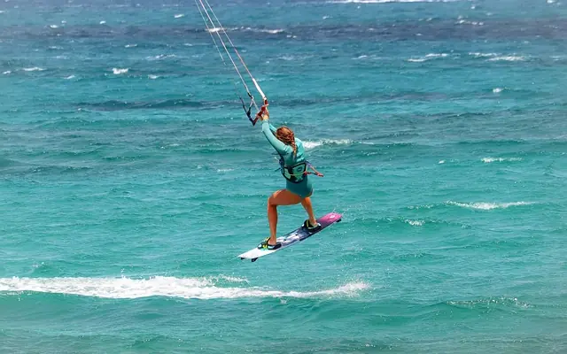 Person kiteboarding on turquoise ocean water, Chuchungi House, Lamu Archipelago, Kenya
