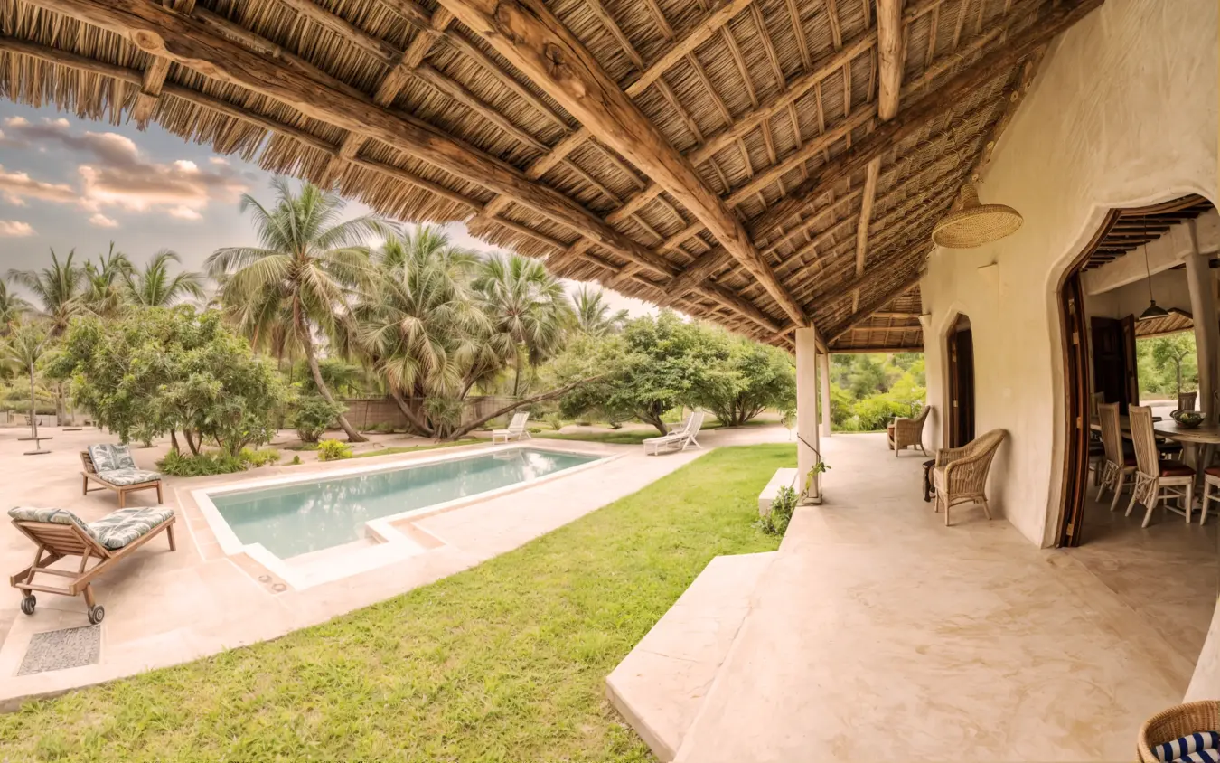Swimming pool with covered veranda and manicured gardens, Chuchungi House, Lamu Archipelago, Kenya