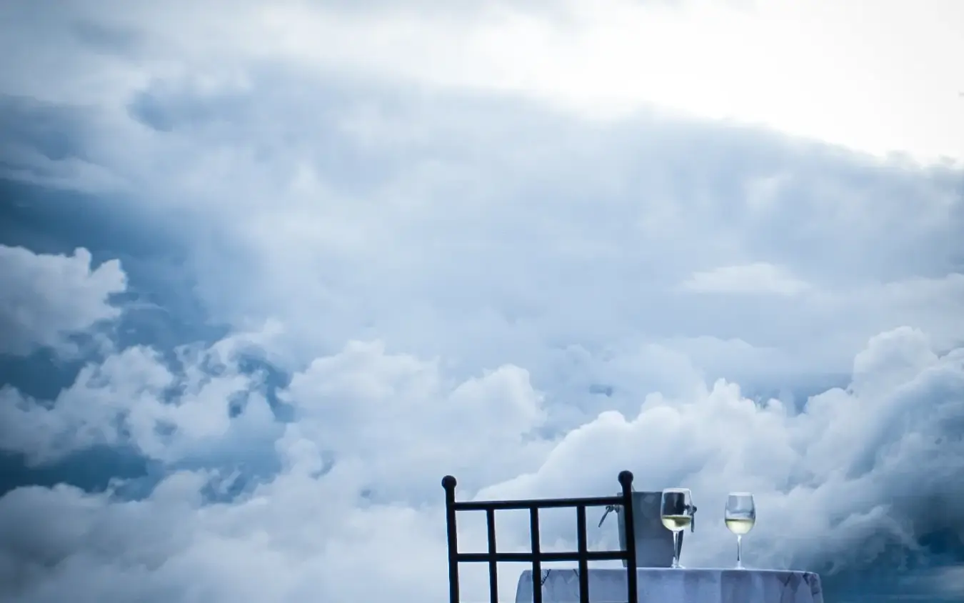 Dining table set above clouds with mountain vista, Clouds Mountain Gorilla Lodge, Bwindi Impenetrable Forest, Uganda