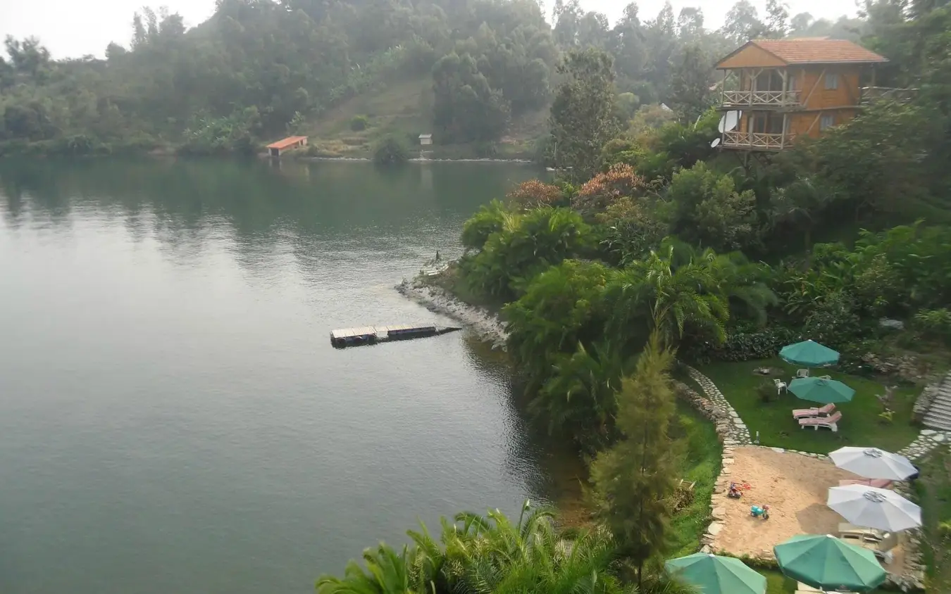 Waterfront lodge with terraced garden overlooking calm lake surrounded by forest, Cormoran Lodge, Lake Kivu, Rwanda