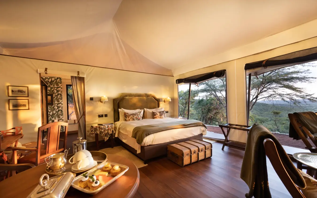 Luxury bedroom tent with views of African landscape, Cottar’s 1920s Camp, Maasai Mara, Kenya