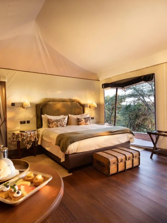 Luxury bedroom tent with views of African landscape, Cottar’s 1920s Camp, Maasai Mara, Kenya