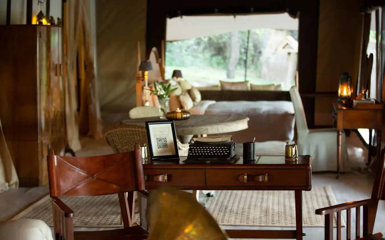 Colonial-style sitting room with desk and views to savanna, Cottar’s 1920s Camp, Maasai Mara, Kenya