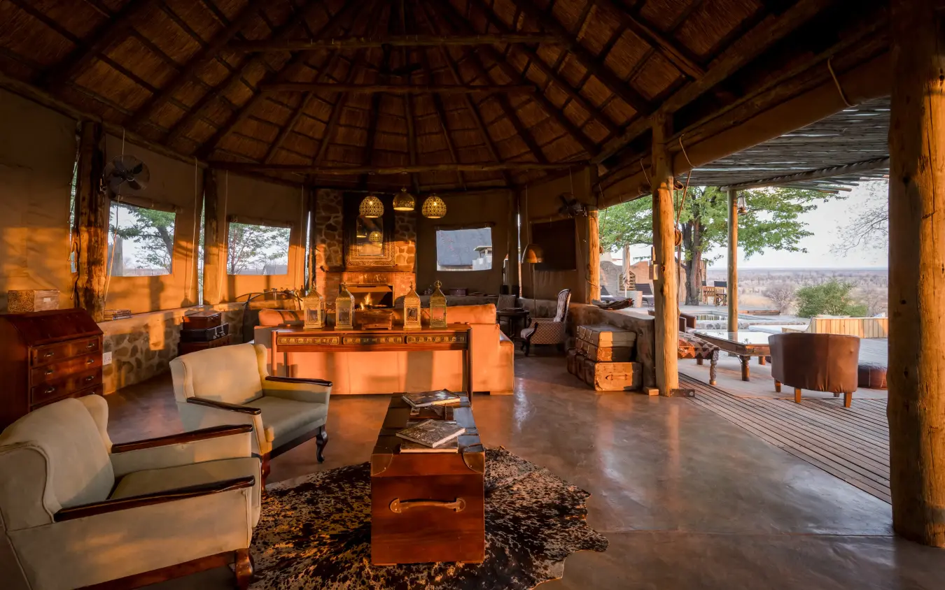 Circular thatched lodge interior with wooden furnishings and valley views, Daka Plains Camp, Hwange National Park, Zimbabwe