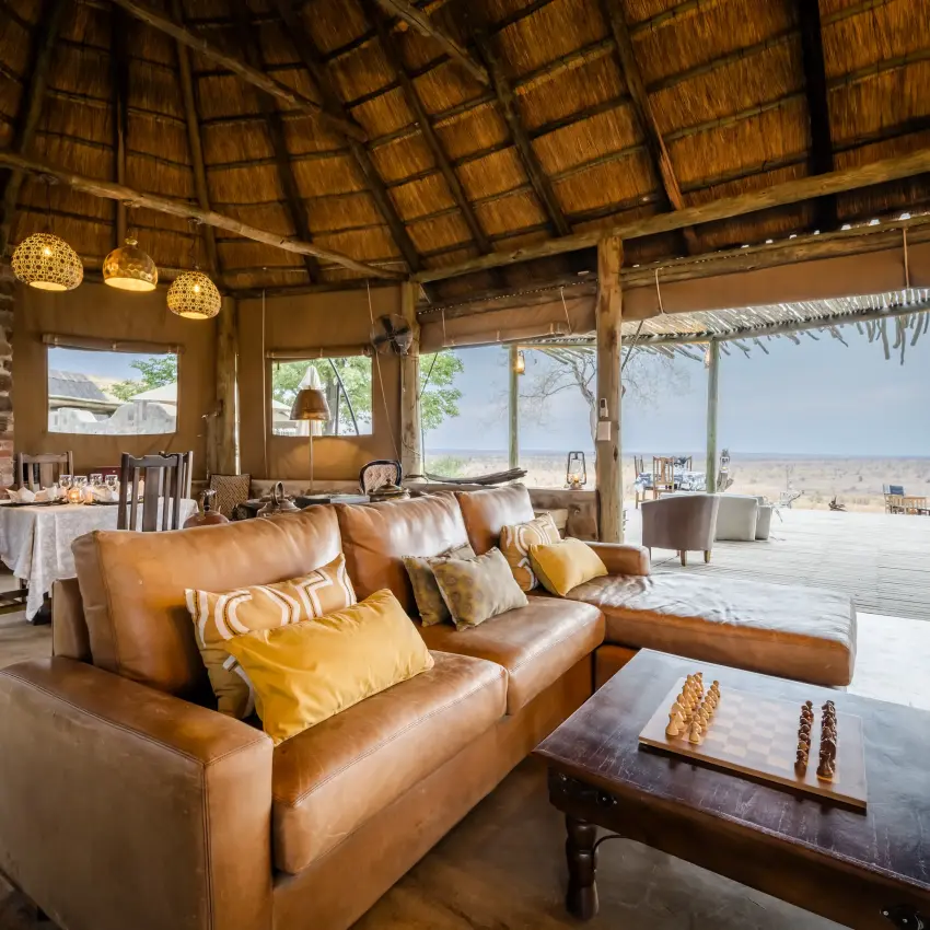 Open-sided lodge interior with leather seating and savanna views, Daka Plains Camp, Hwange National Park, Zimbabwe