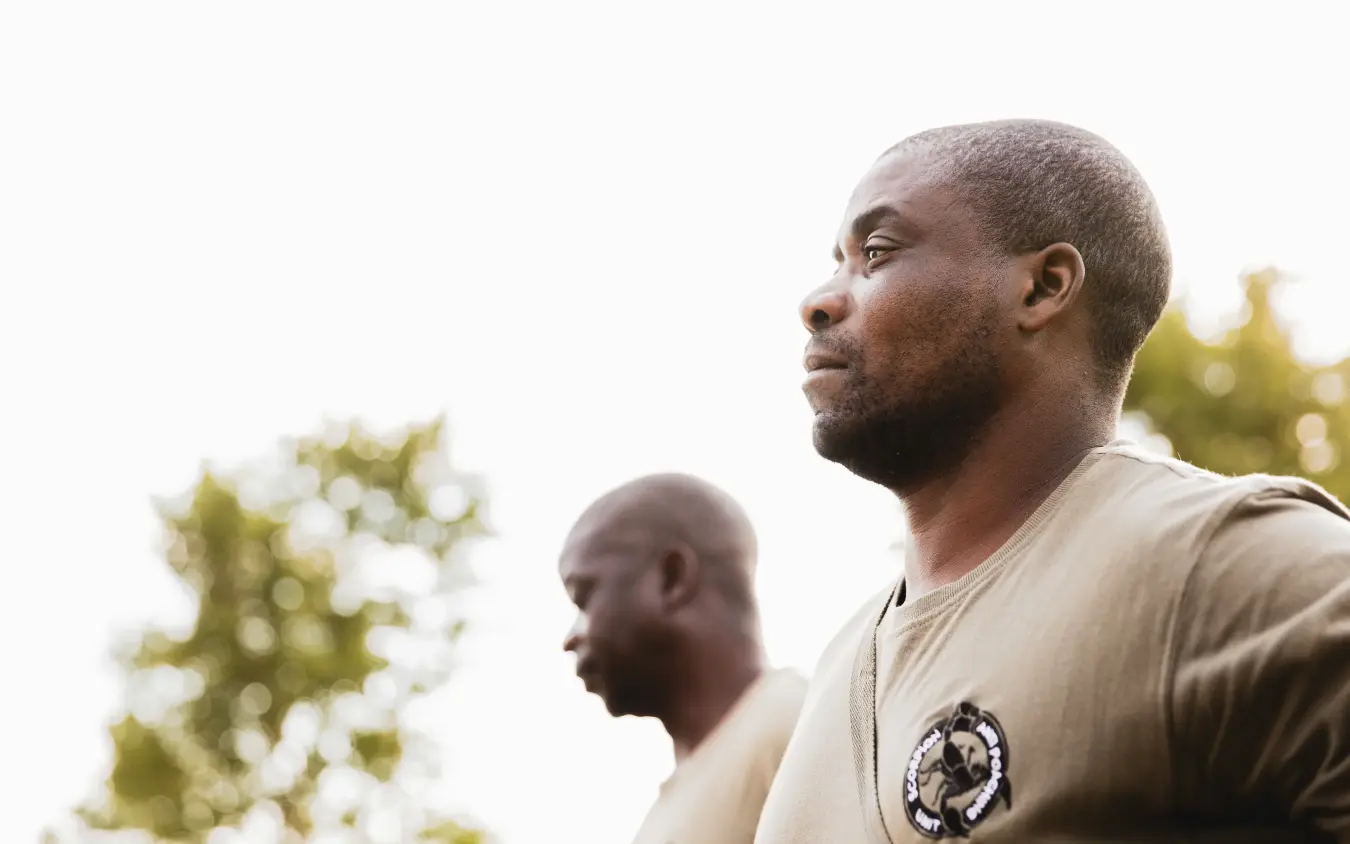 Two men looking out over landscape with trees, Davison’s Camp, Hwange National Park, Zimbabwe