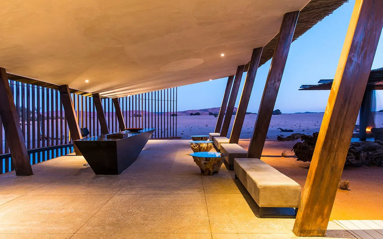 Beachfront pavilion at twilight overlooking ocean and islands, Dead Valley Lodge, Sossusvlei, Namibia