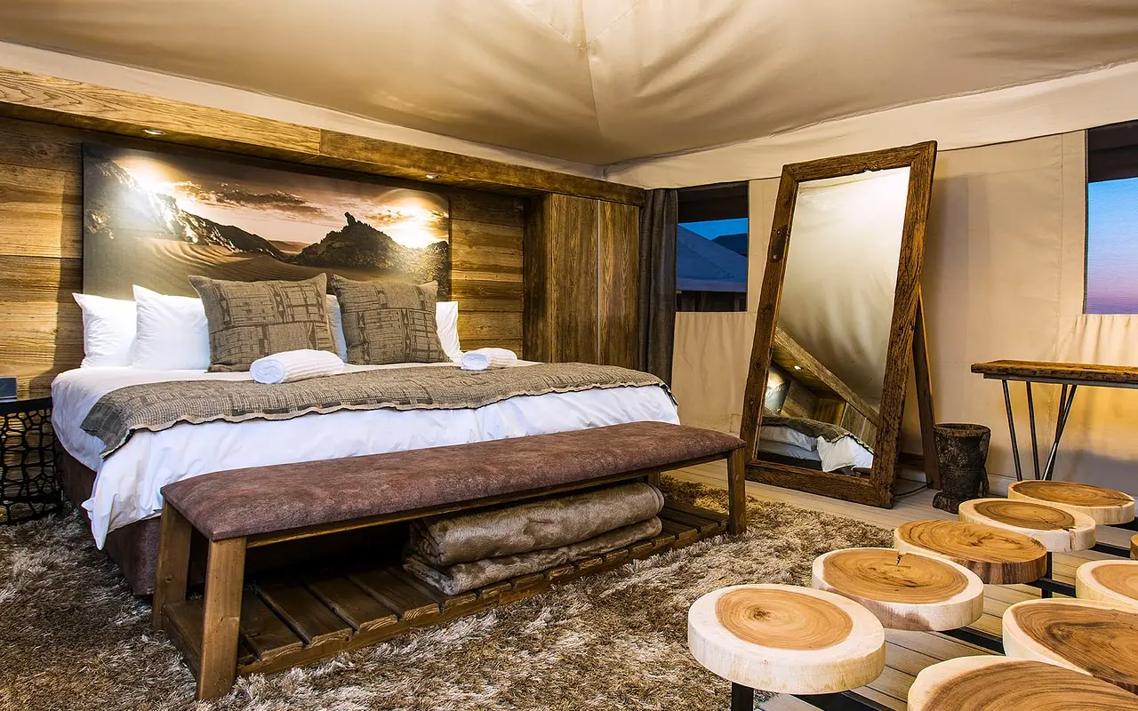 Luxury bedroom with wooden accents and evening views, Dead Valley Lodge, Sossusvlei, Namibia
