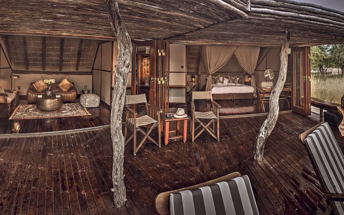 Safari lodge deck with seating areas and guest accommodations, Deception Valley Lodge, Central Kalahari, Botswana