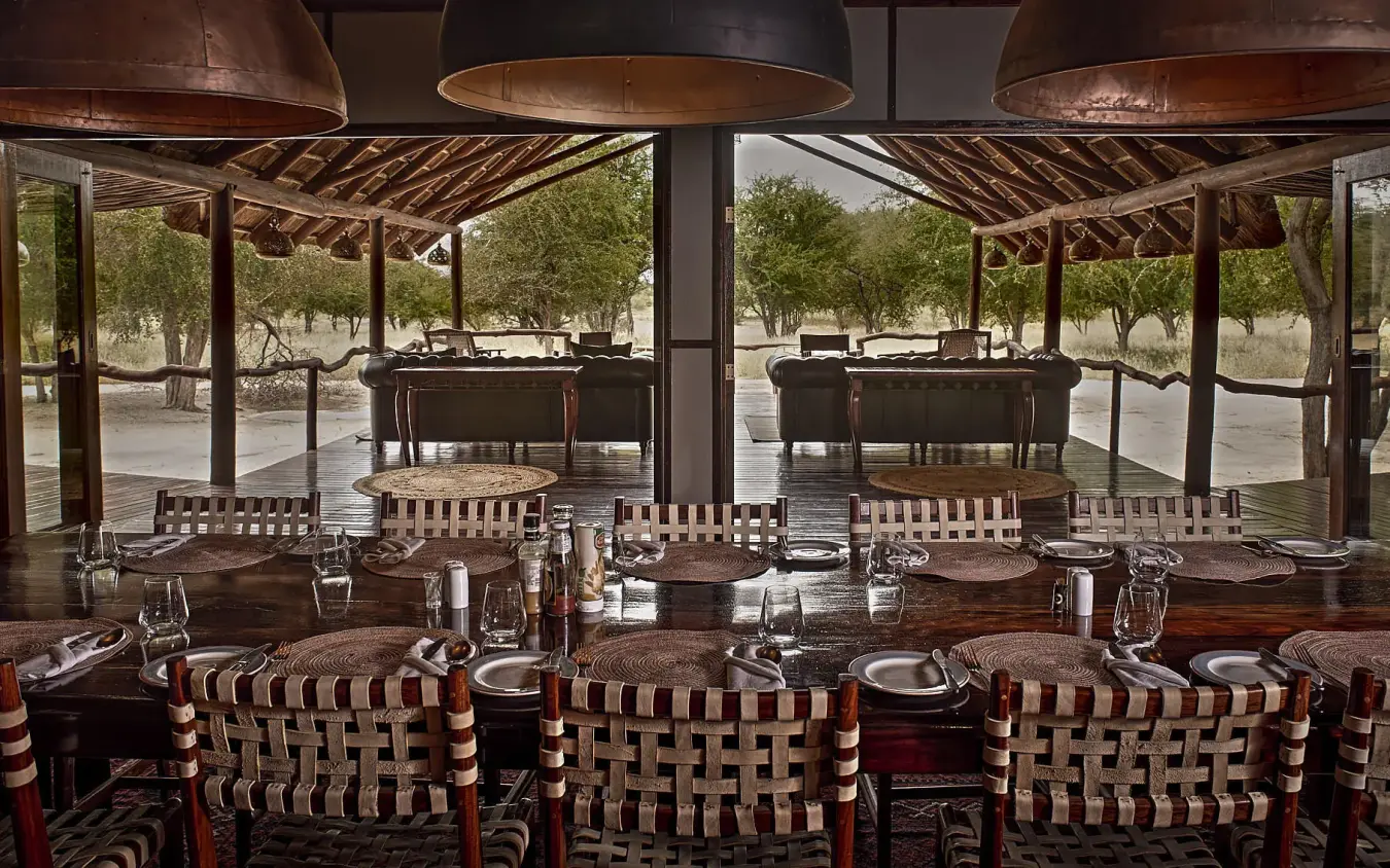 Dining pavilion with set tables and open views to grounds, Deception Valley Lodge, Central Kalahari, Botswana