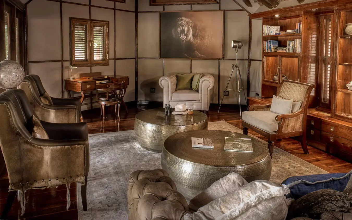 Luxury lounge with leather seating and decorative metallic tables, Deception Valley Lodge, Central Kalahari, Botswana