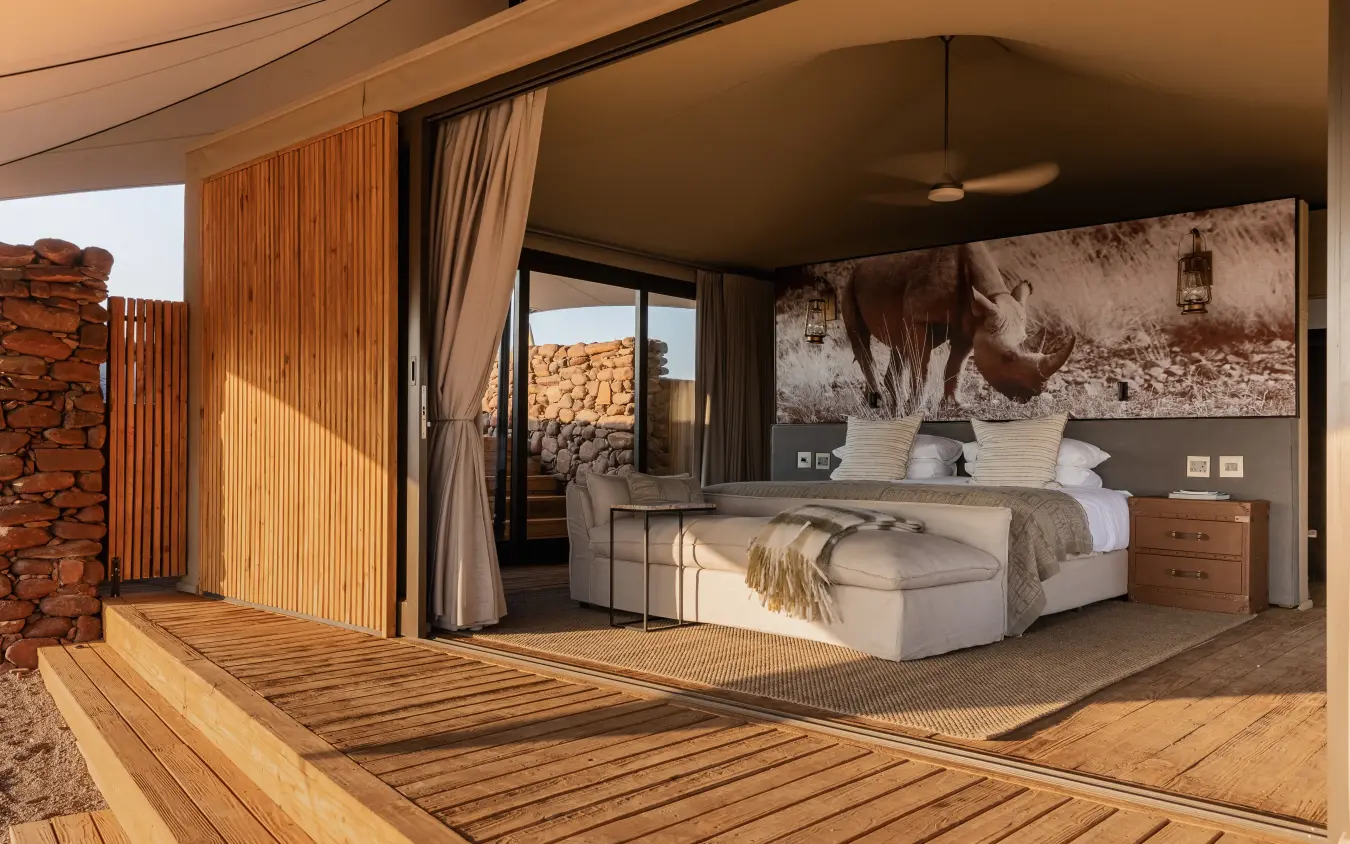 Modern safari lodge bedroom with expansive views of rocky landscape, Desert Rhino Camp, Damaraland, Namibia
