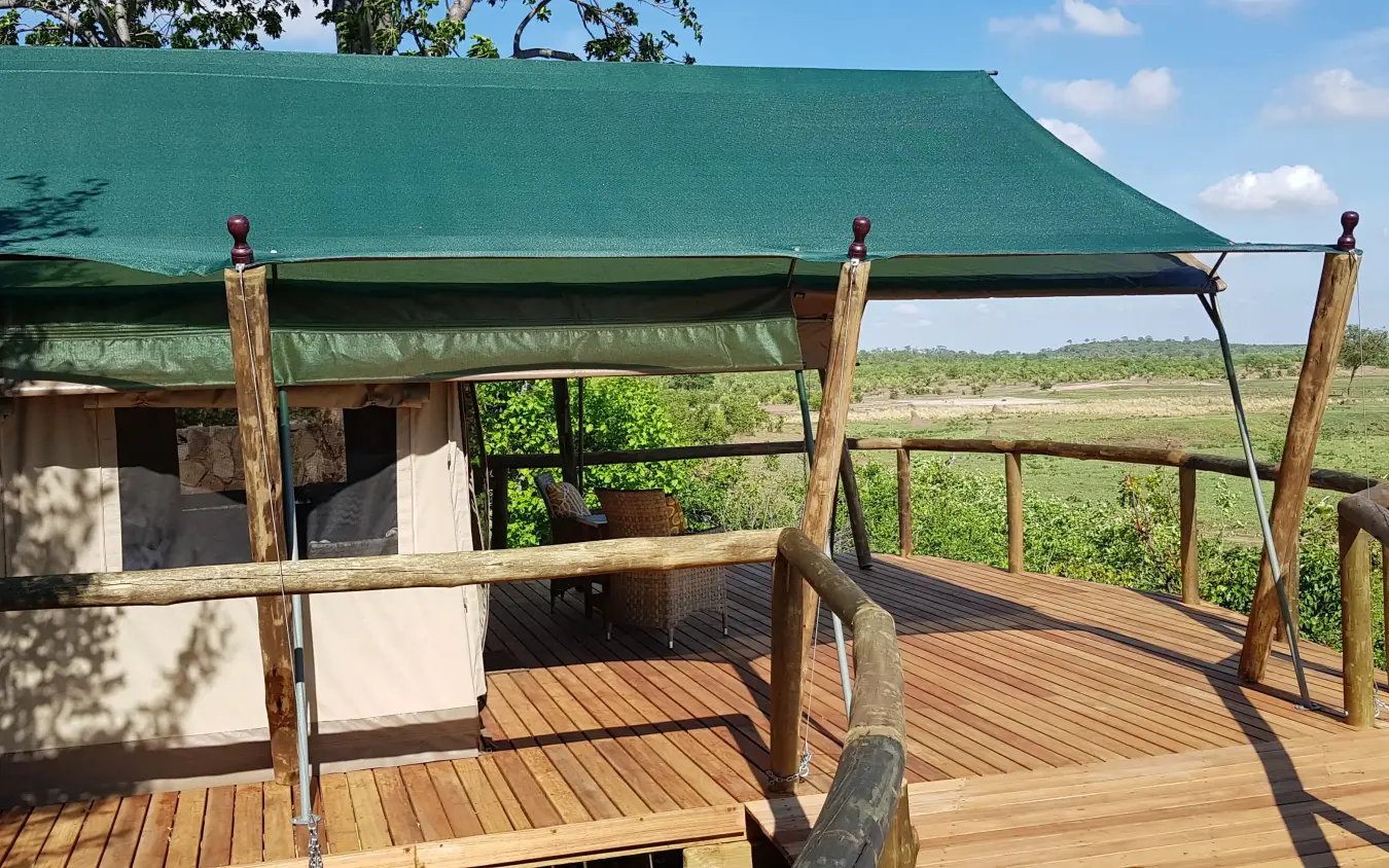 Safari lodge deck with green canvas roof overlooking savanna landscape, Deteema Springs Camp, Hwange National Park, Zimbabwe