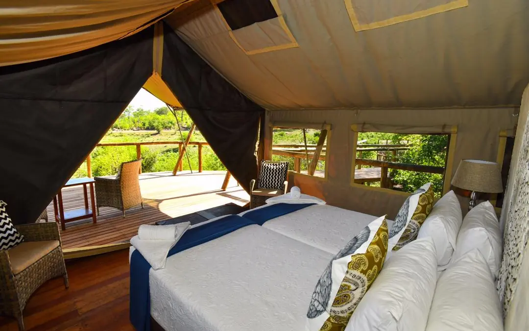 Luxury safari tent bedroom with open-air deck and valley views, Deteema Springs Camp, Hwange National Park, Zimbabwe