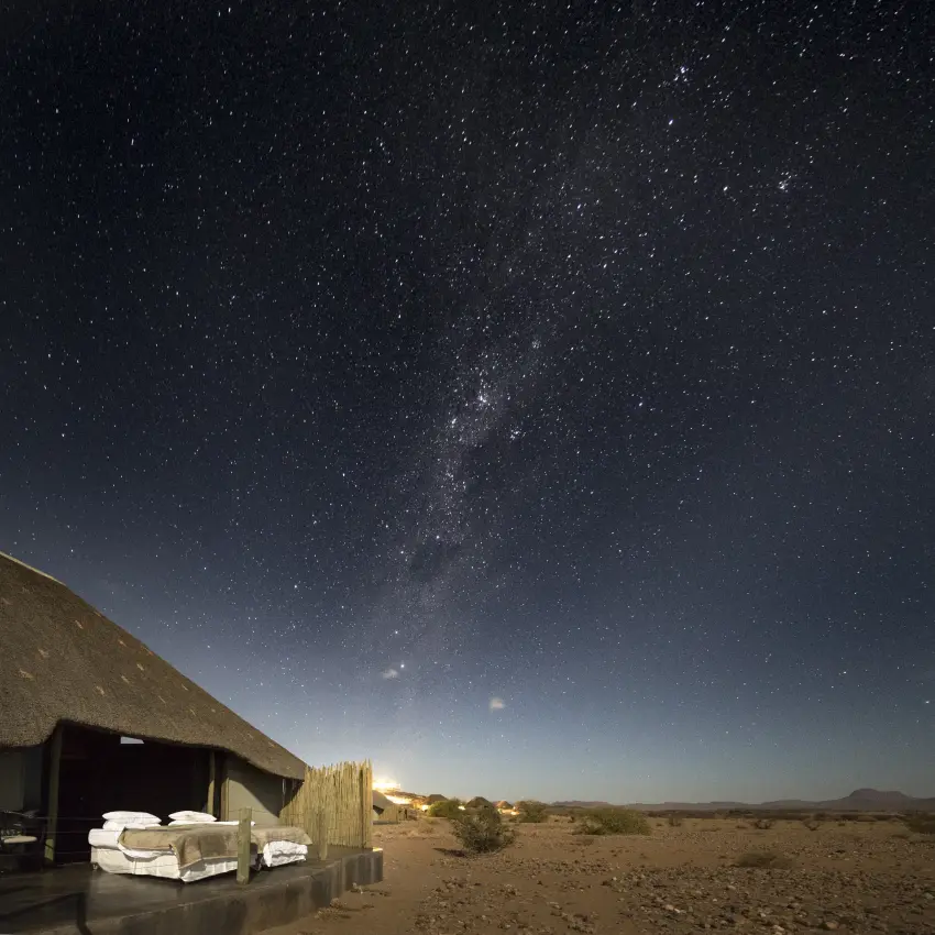 Open-air bedroom pavilion under starlit desert sky at night, Doro Nawas Camp, Damaraland, Namibia