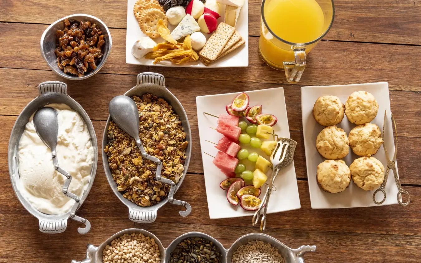 Breakfast spread with pastries, fruits, and beverages, Duba Explorers Camp, The Okavango Delta, Botswana