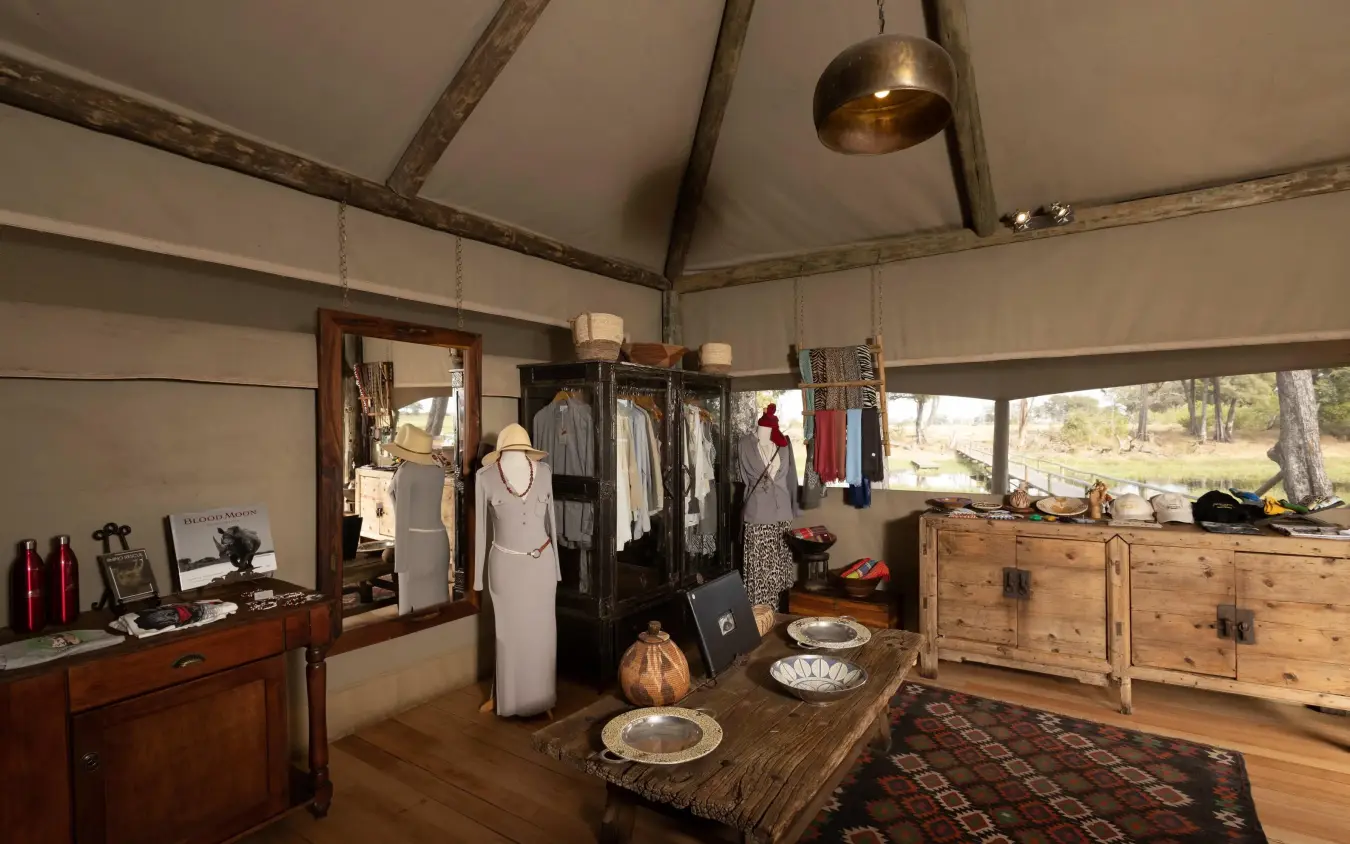 Interior of canvas tent with furniture and clothing displays, Duba Explorers Camp, The Okavango Delta, Botswana
