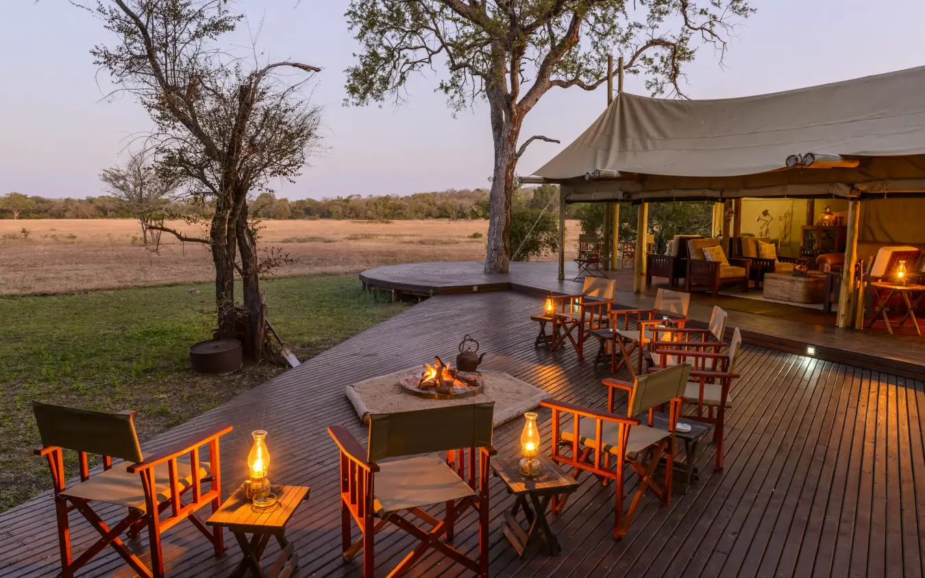 Evening deck with firepit overlooking open plains, Duba Plains, The Okavango Delta, Botswana