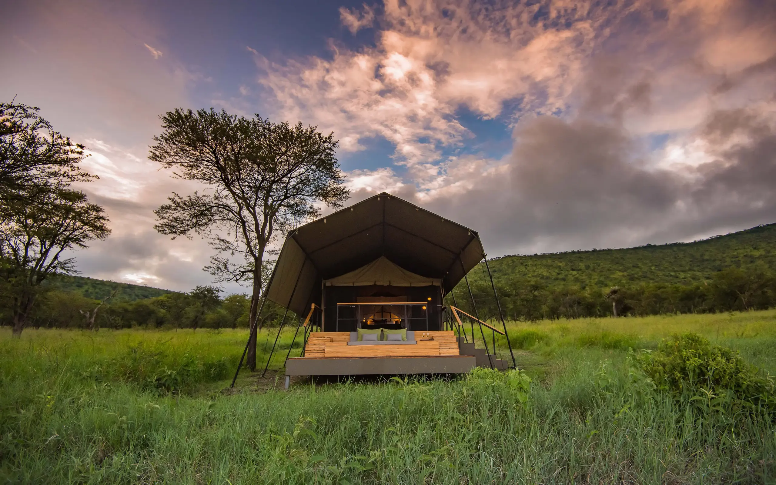 Canvas safari tent with wooden deck in grassland, Dunia Camp, Serengeti National Park, Tanzania