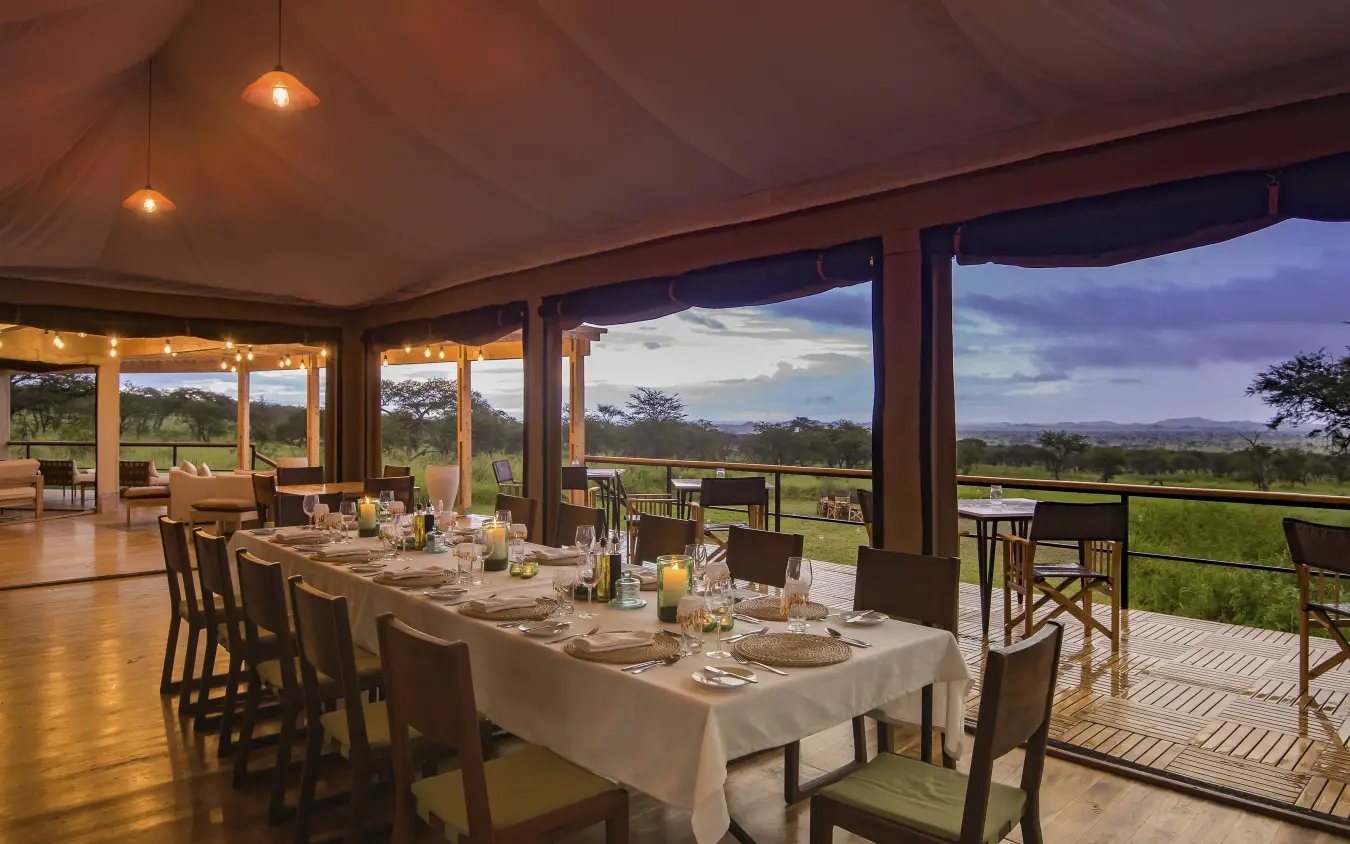 Dining pavilion with set table overlooking savanna landscape, Dunia Camp, Serengeti National Park, Tanzania