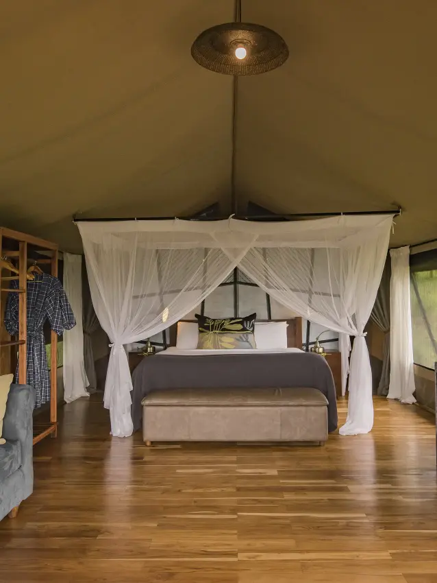 Spacious safari tent bedroom with four-poster bed and furnishings, Dunia Camp, Serengeti National Park, Tanzania