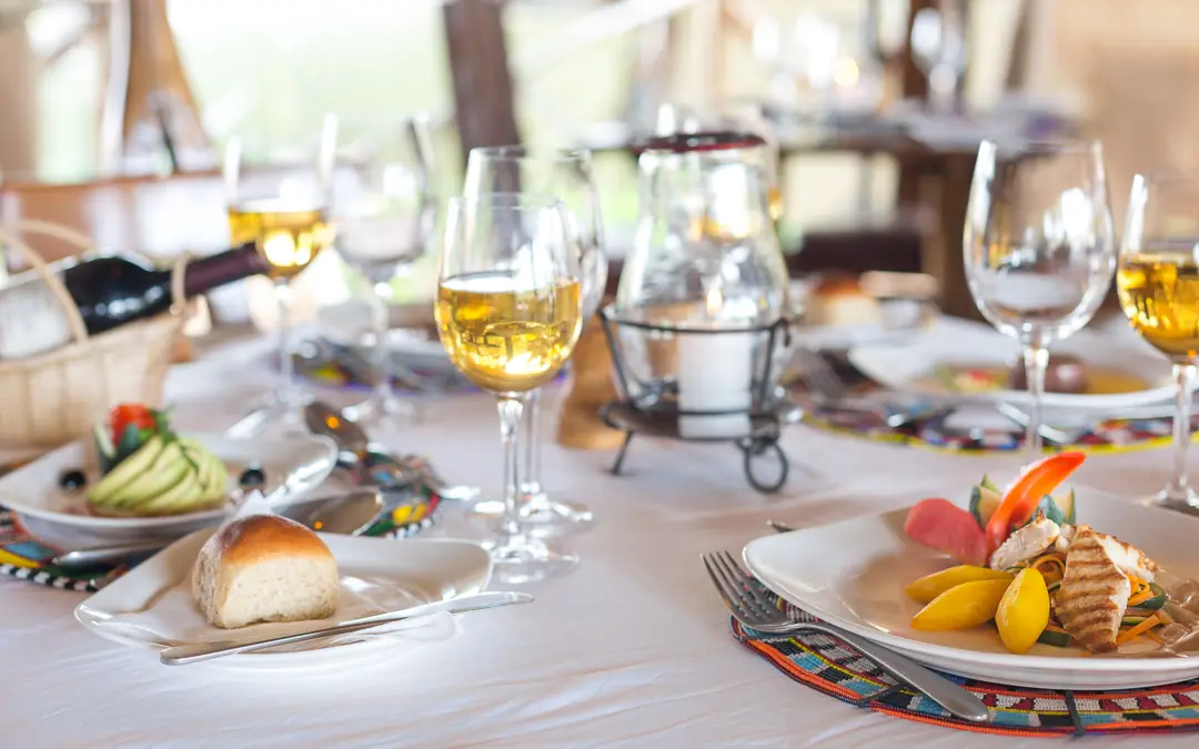 Outdoor dining table set with plated cuisine and wine glasses, Elephant Bedroom Camp, Samburu Reserve, Kenya