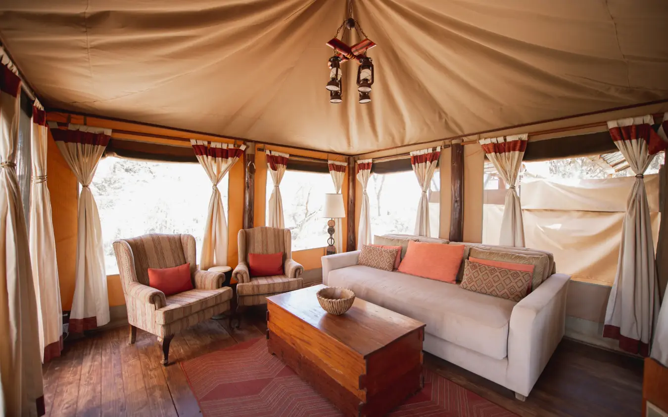 Safari lodge interior with cream canvas walls and draped fabric furnishings, Elephant Bedroom Camp, Samburu Reserve, Kenya