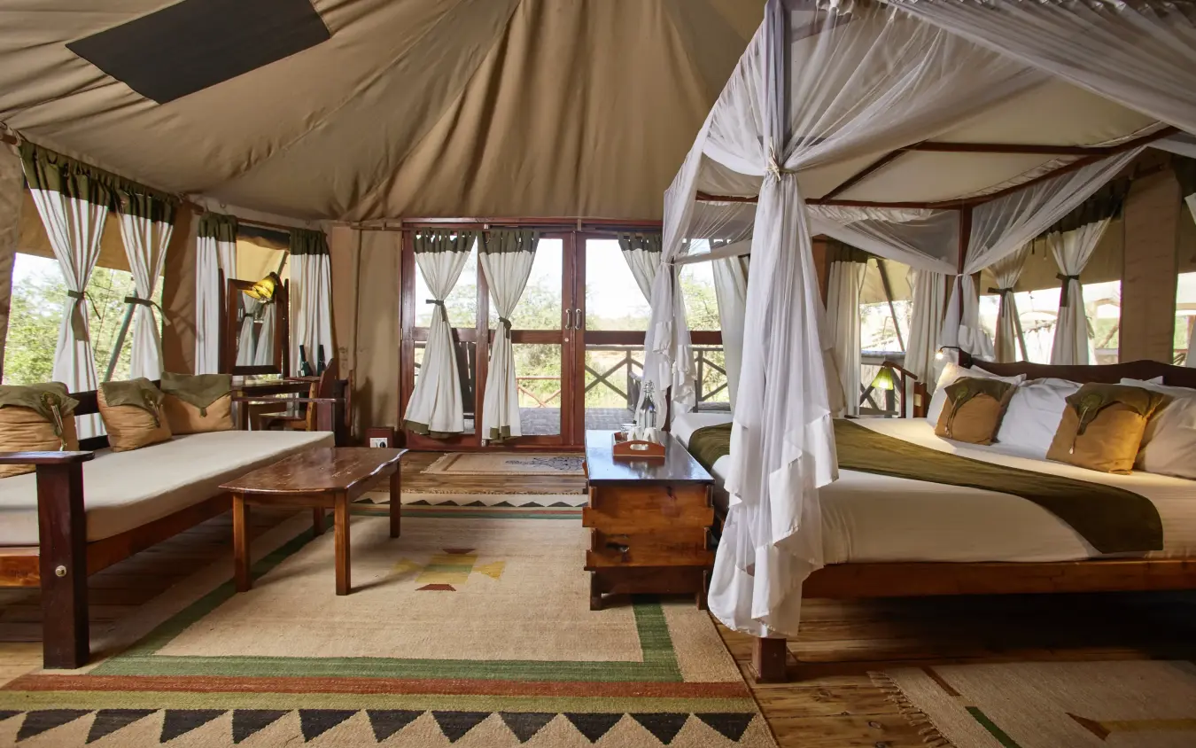 Luxury safari tent interior with four-poster bed and lounge area, Elephant Bedroom Camp, Samburu Reserve, Kenya