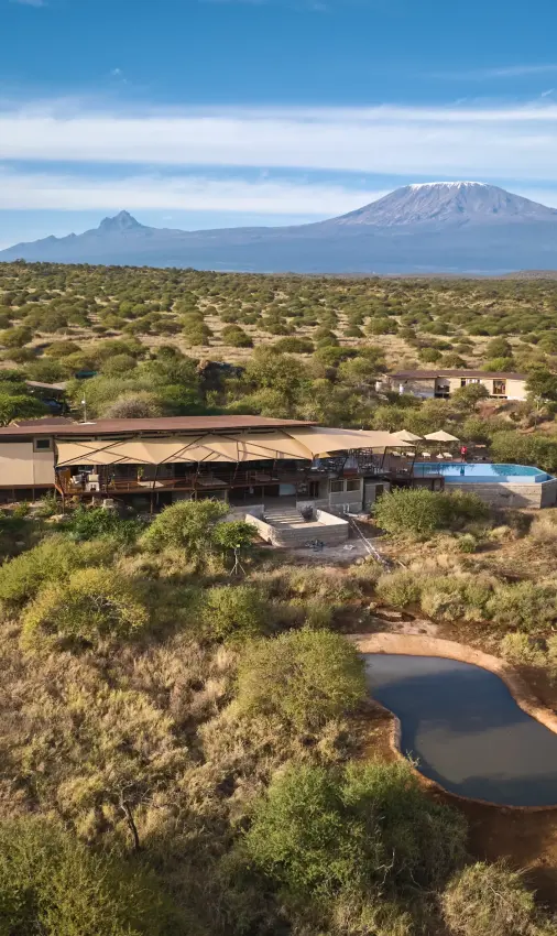 Luxury lodge with pool overlooking savanna landscape and snow-capped volcano, Elephant Gorge Camp, Amboseli and Chyulu Hills, Kenya