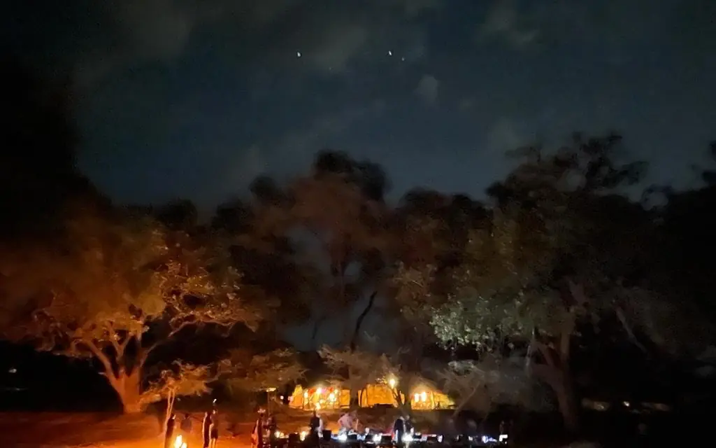 Illuminated safari lodge at night under starry sky, Elephant Watch Camp, Samburu Reserve, Kenya