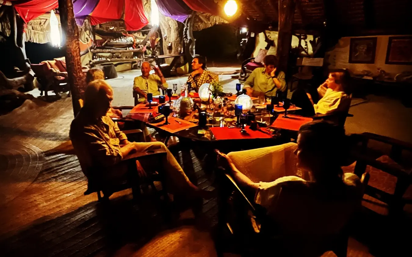 Evening dining setup under draped tent with warm lighting, Elephant Watch Camp, Samburu Reserve, Kenya