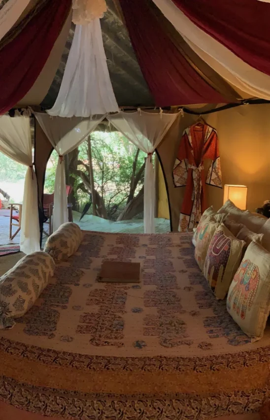 Safari tent bedroom with draped fabric and open views, Elephant Watch Camp, Samburu Reserve, Kenya