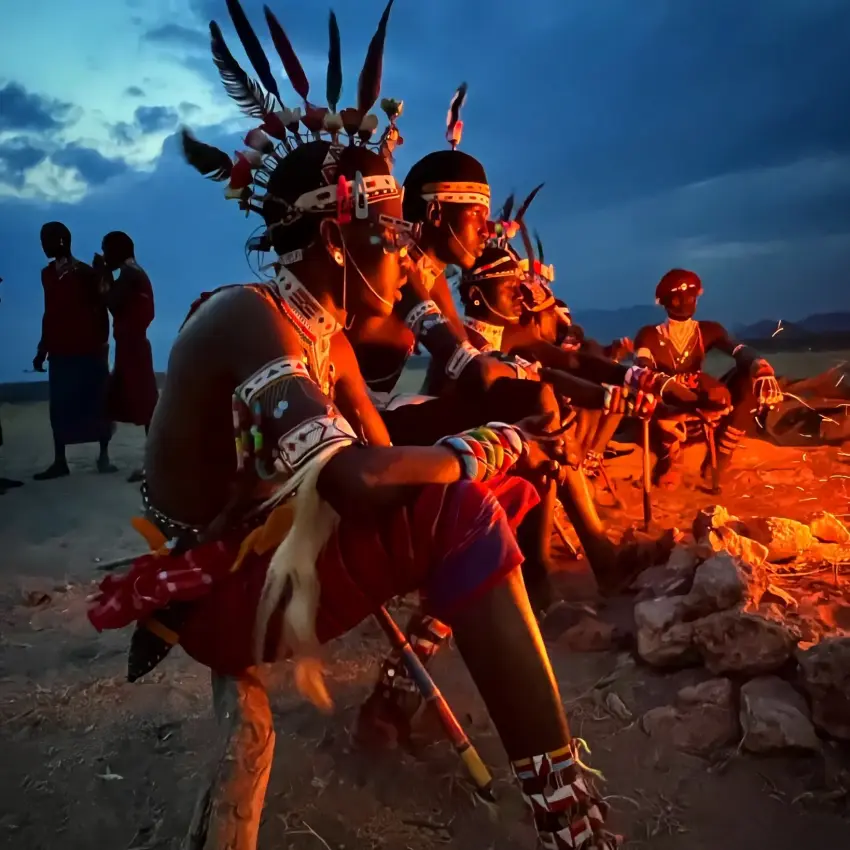 Indigenous warriors in traditional dress perform at dusk, Samburu Reserve, Kenya