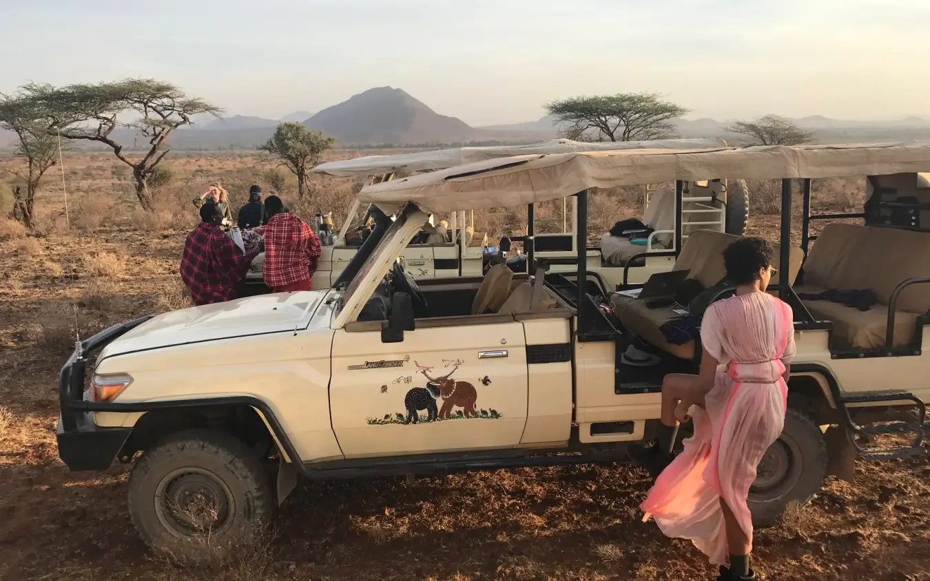 Safari vehicle with guests observing landscape and mountain, Elephant Watch Camp, Samburu Reserve, Kenya