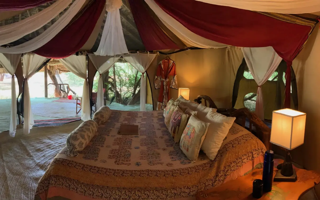 Safari tent bedroom with draped fabric and open views, Elephant Watch Camp, Samburu Reserve, Kenya