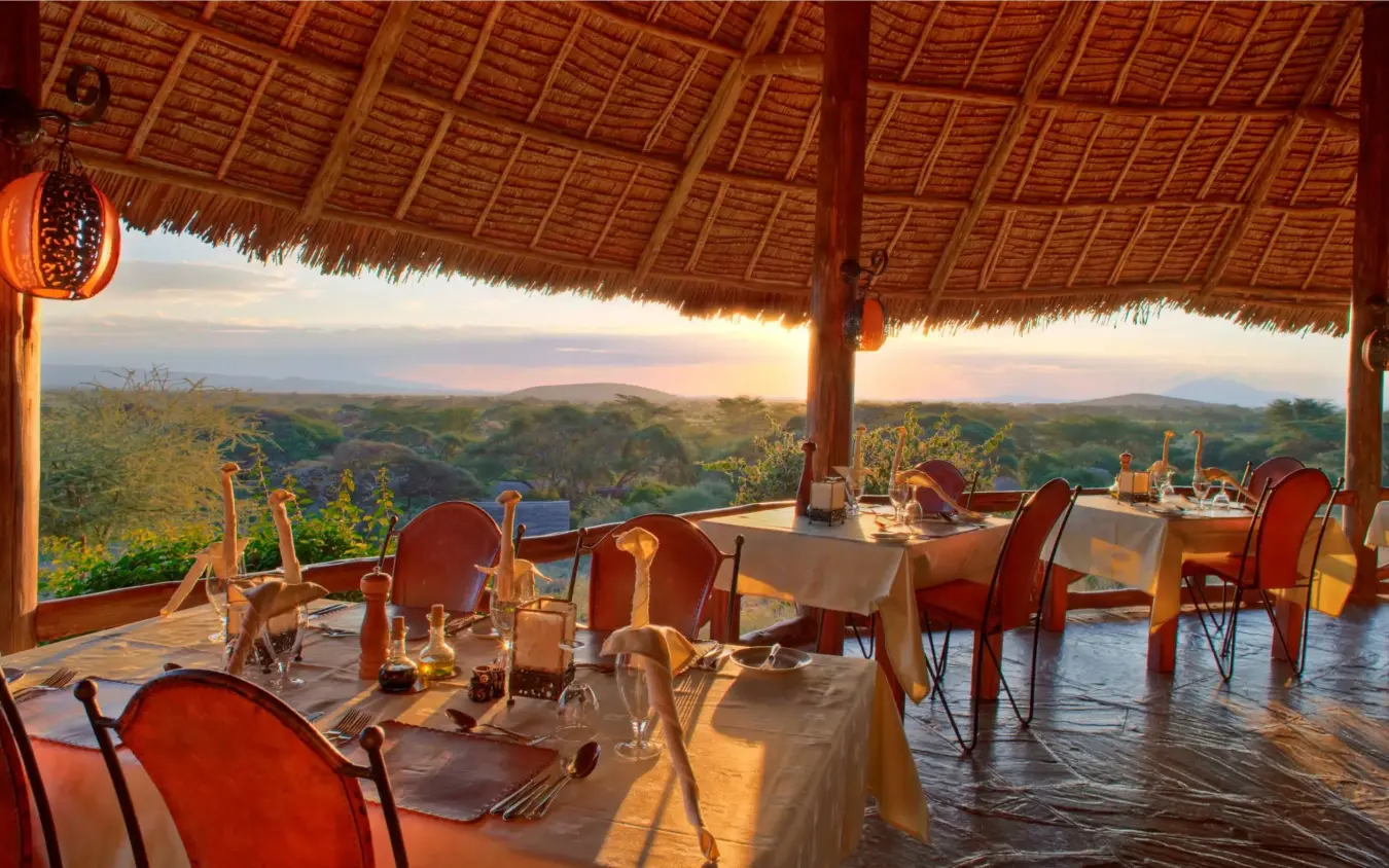 Dining pavilion overlooking savanna landscape at sunset, Tortilis Camp, Amboseli and Chyulu Hills, Kenya
