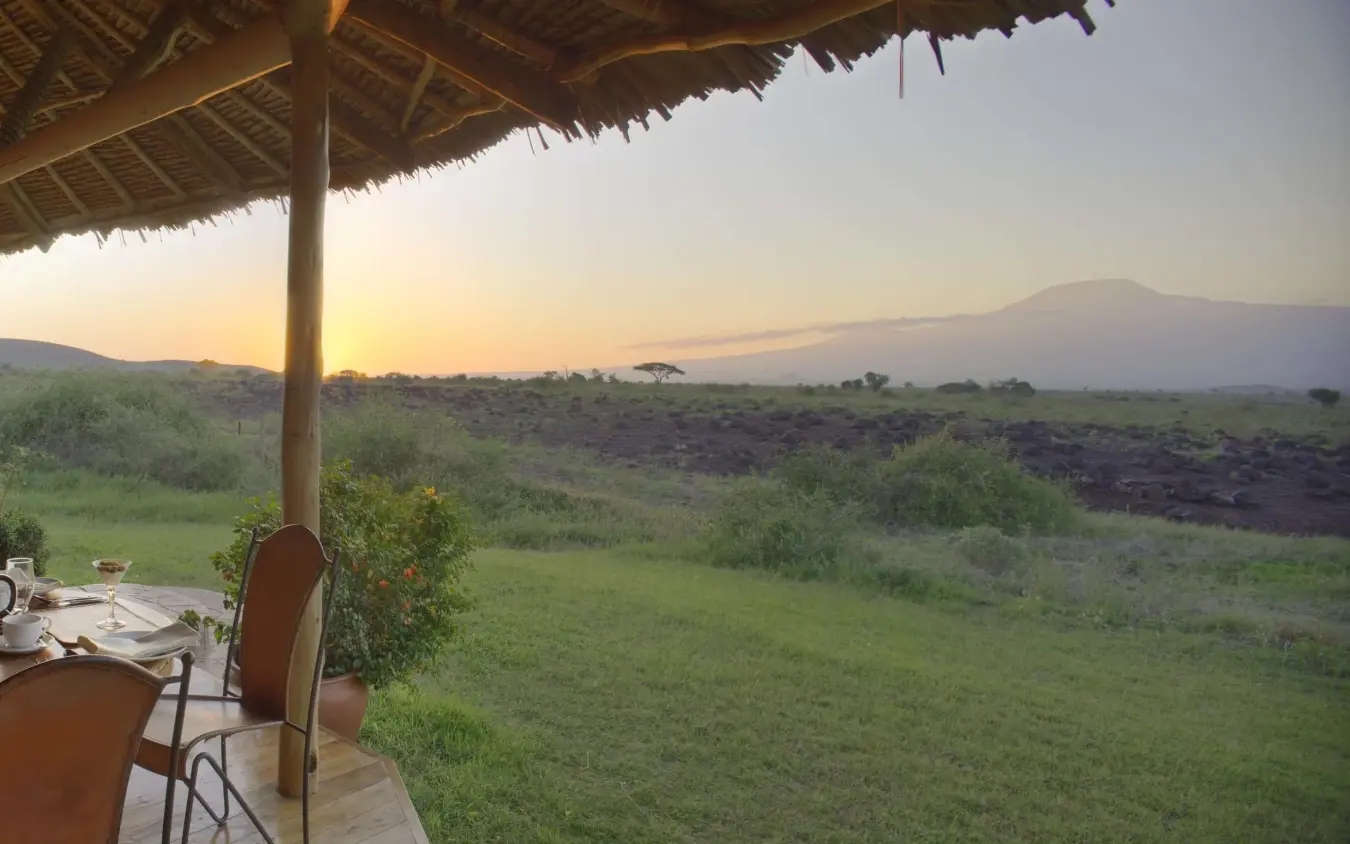 Dining pavilion overlooking savanna landscape at sunset, Tortilis Camp, Amboseli and Chyulu Hills, Kenya