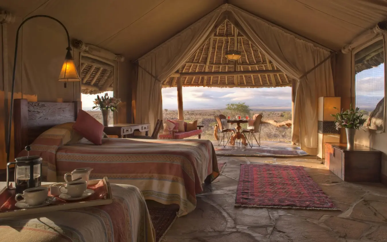 Safari tent bedroom with mountain views and outdoor seating, Tortilis Camp, Amboseli and Chyulu Hills, Kenya